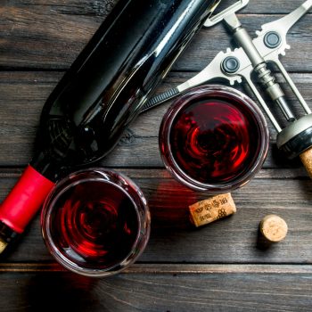 Wine background. Red wine with corkscrew.